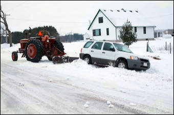 Tractor towing Car out of Ditch after Self-Sabotage