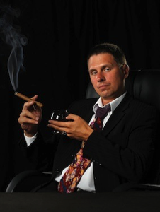 man smoking with cognac in hand